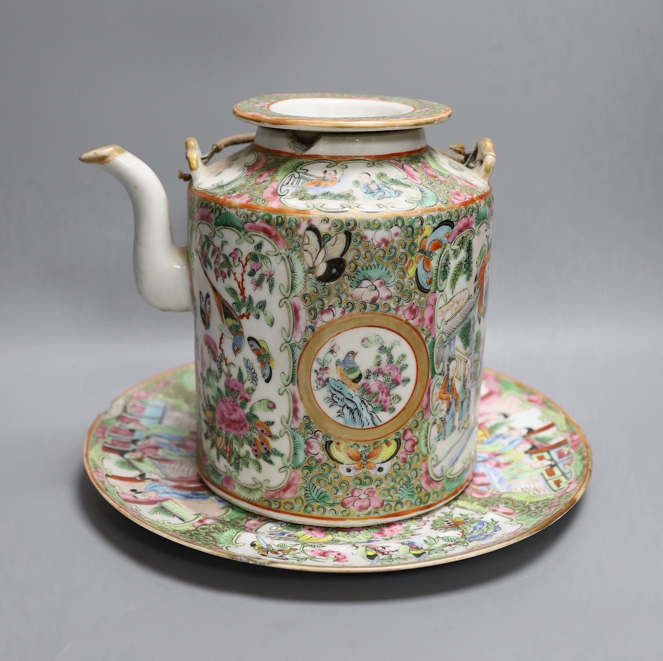 A Cantonese famille rose plate and teapot with cover, a pair of Chinese seated dogs, and a tureen with cover and oval dish, And a Chinese faux lacquer dragon and Phoenix dish, teapot 18 cms high